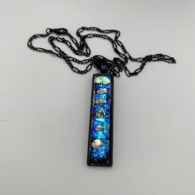 Necklace with a rectangular pendant featuring blue and silver elements on a white background